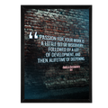 Framed print with a motivational quote on a brick wall background